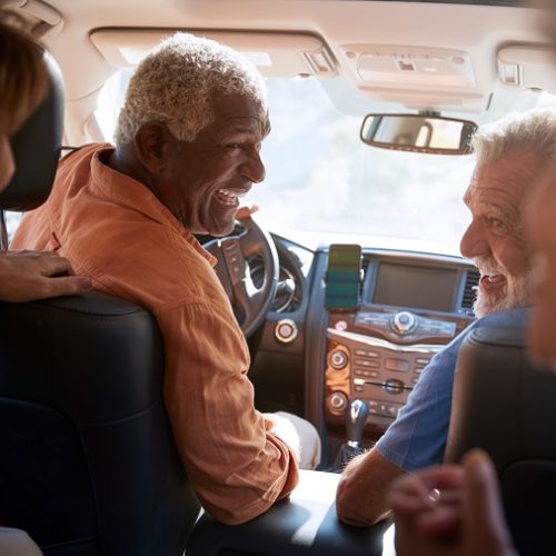 Group Of Senior Friends Enjoying Road Trip In Car Together